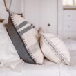 white and blue throw pillows on white bed